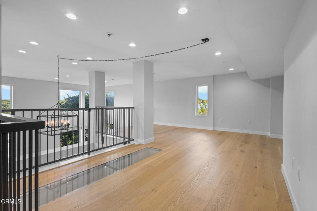1901 South Victoria Avenue, Unit 204 Oxnard, CA 93035 - Photo 33 of 40 a view of an empty room with wooden floor