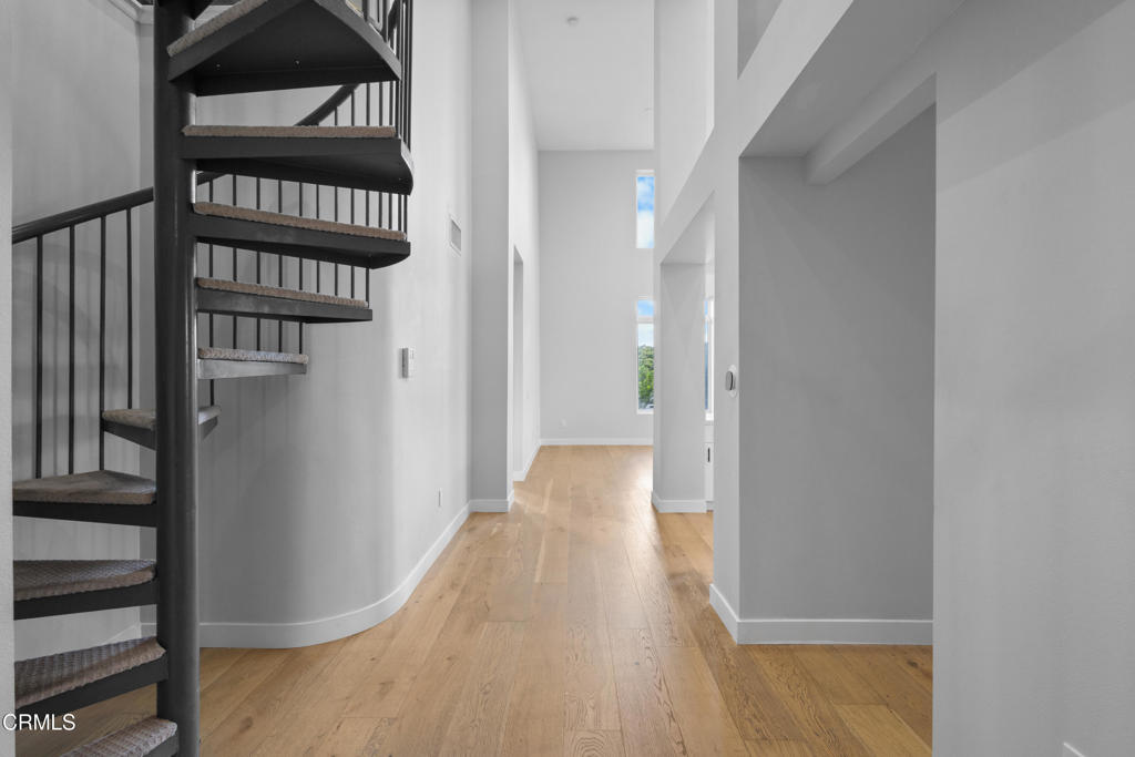 1901 South Victoria Avenue, Unit 204 Oxnard, CA 93035 - Photo 9 of 40 a view of a hallway with wooden floor and staircase