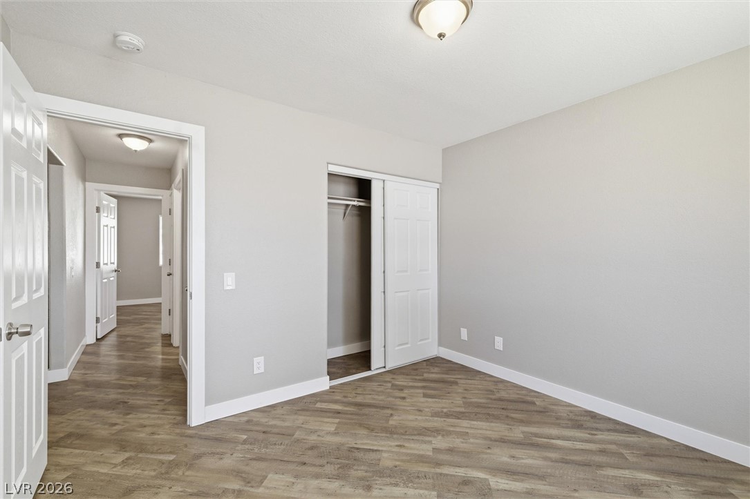 2780 West Simkins Road Pahrump, NV 89060 - Photo 29 of 40 Well-lit sleeping quarters with a convenient closet and wood-look flooring.
