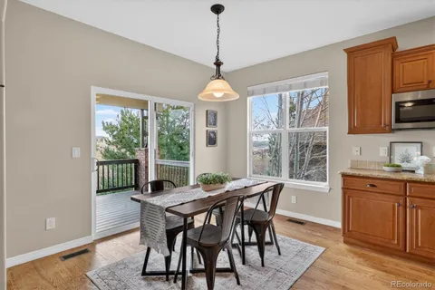 a kitchen with stainless steel appliances granite countertop a stove and cabinets with wooden floor