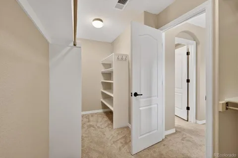 an empty room with closet and windows