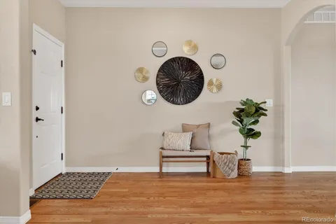 a living room with furniture a dining table and a fireplace