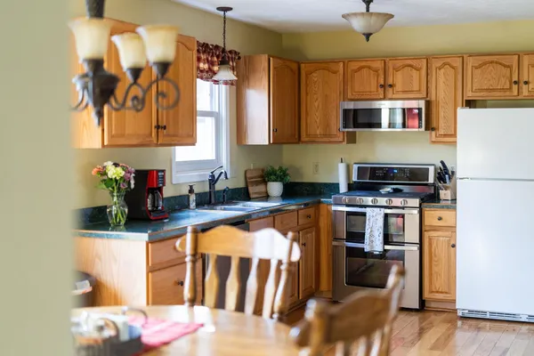 a kitchen with stainless steel appliances granite countertop a stove and a microwave