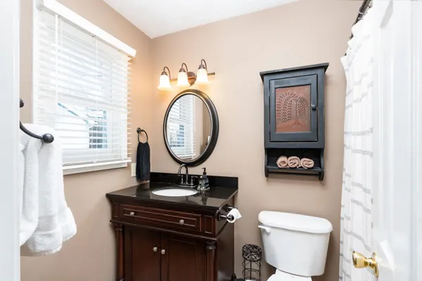 a bedroom with a large bed and a chandelier fan