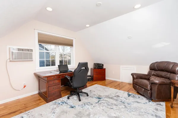 a view of a house with a big yard and large trees