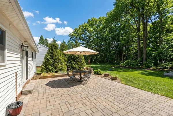 a backyard of a house with yard and outdoor seating