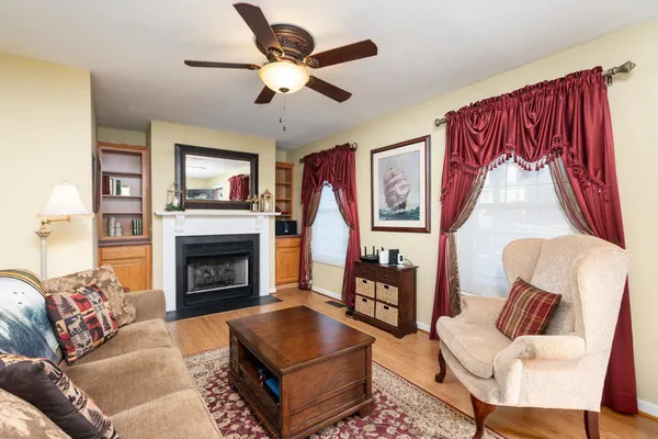 a view of living room with furniture and a fireplace