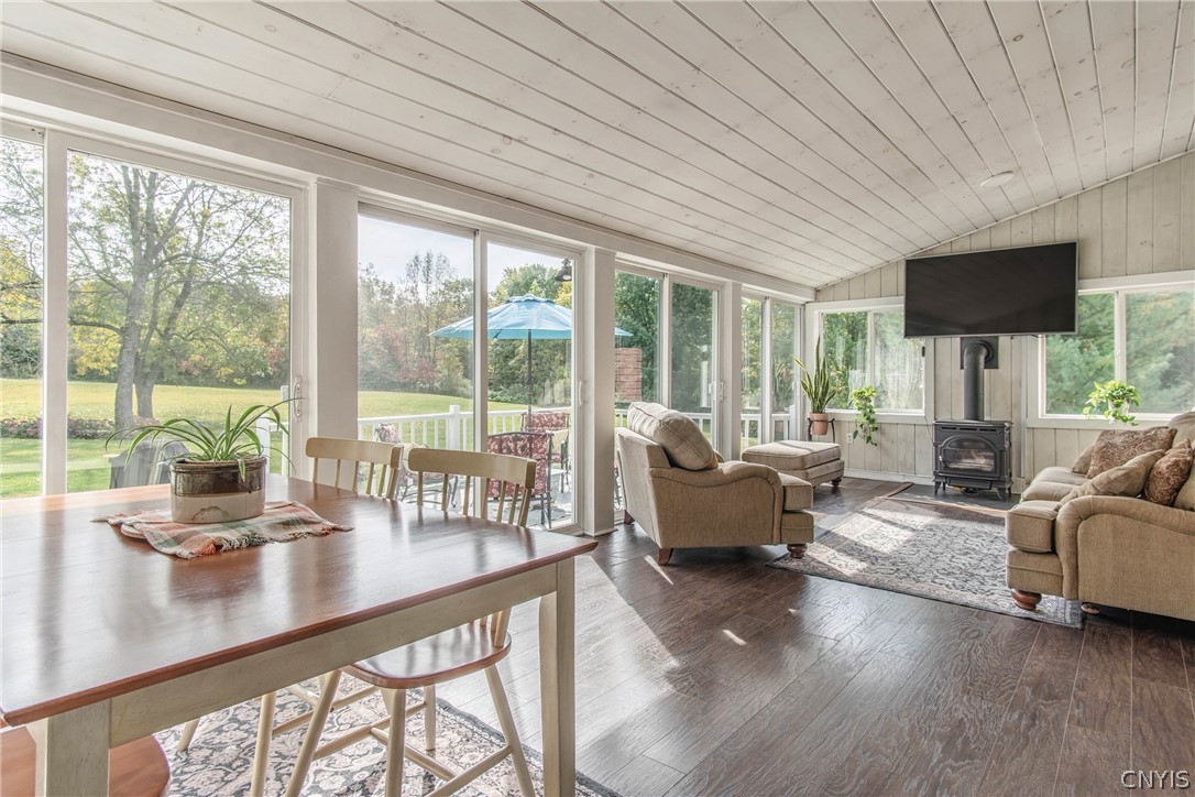 15384 Fuller Road Adams, NY 13606 - Photo 38 of 50 A vaulted wood-paneled ceiling and matching plank flooring define this sun-drenched living space.
