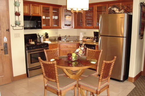 500 Village Road, Unit 302 Breckenridge, CO 80424 - Photo 6 of 13 a view of a dining room with furniture and a refrigerator