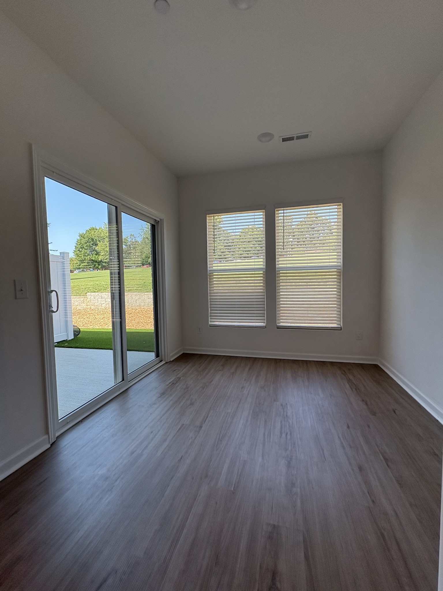 7144 Mapleside Lane, Unit 19 Fairview, TN 37062 - Photo 11 of 26 an empty room with wooden floor and windows