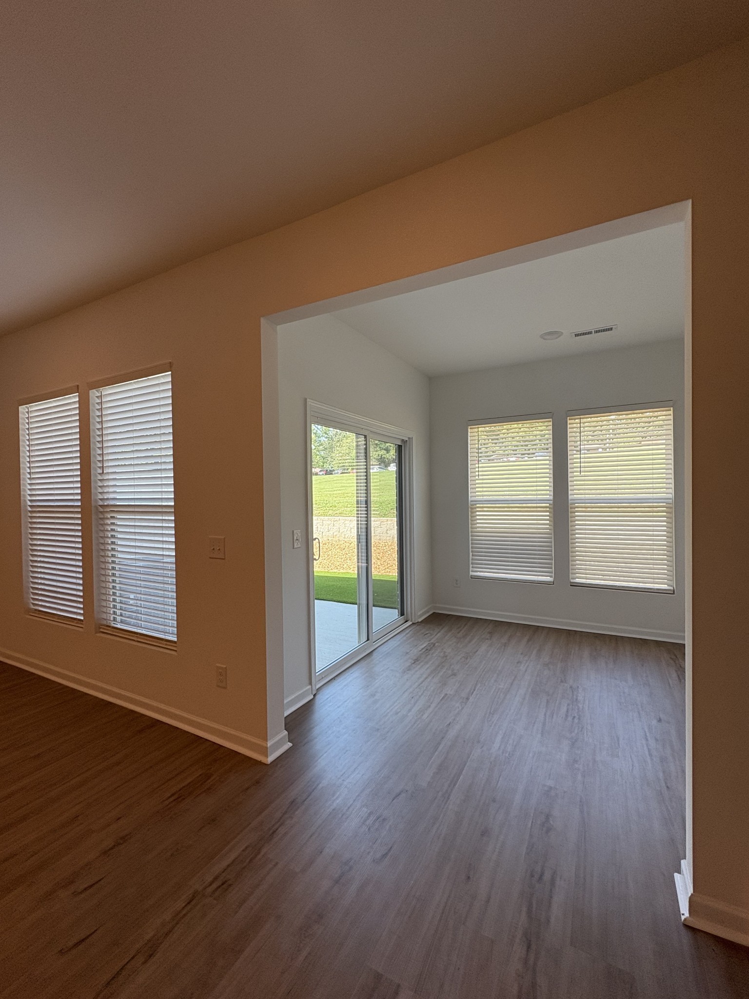 7144 Mapleside Lane, Unit 19 Fairview, TN 37062 - Photo 12 of 26 an empty room with wooden floor and windows
