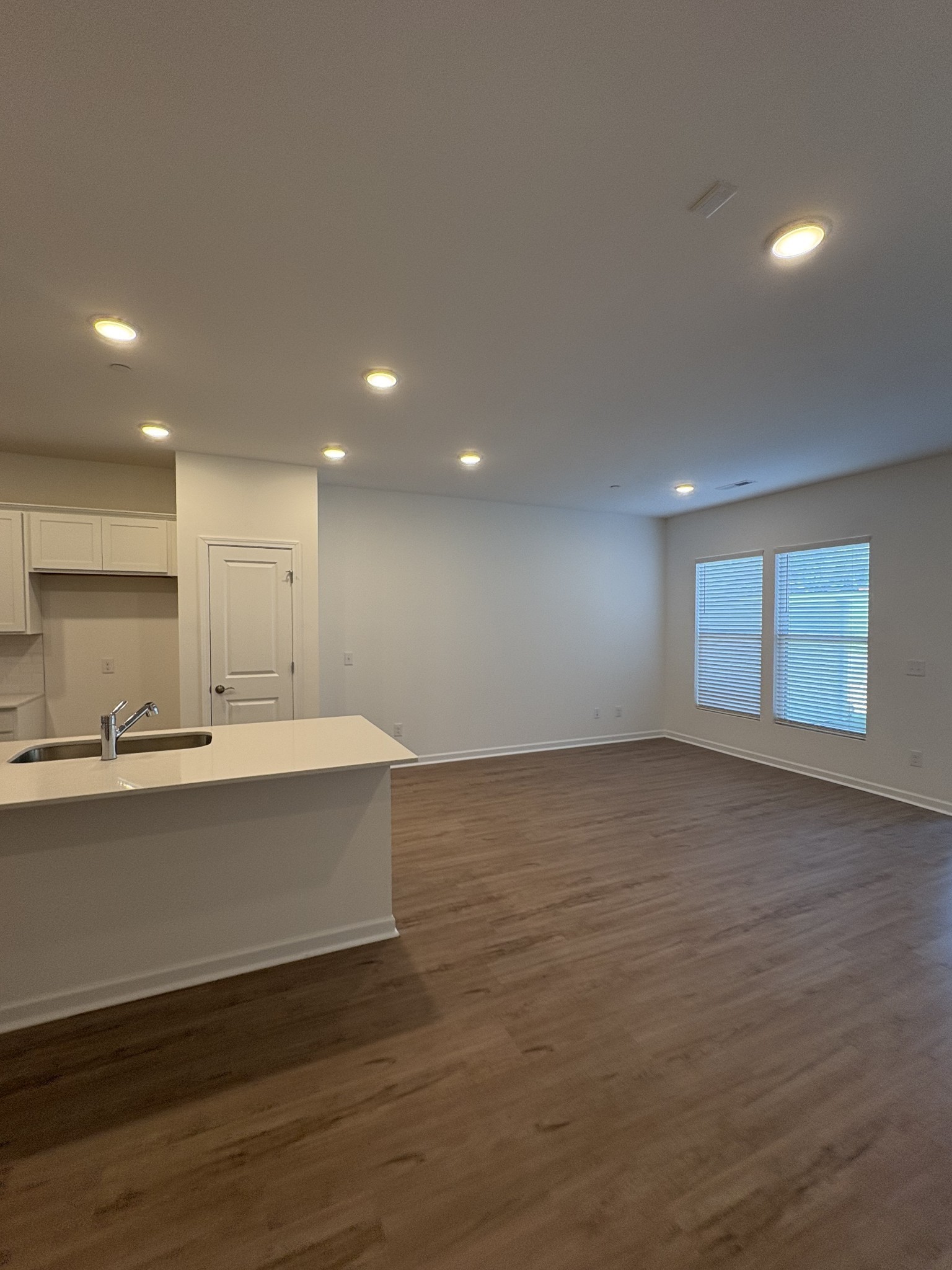 7144 Mapleside Lane, Unit 19 Fairview, TN 37062 - Photo 13 of 26 a view of kitchen and empty room with wooden floor