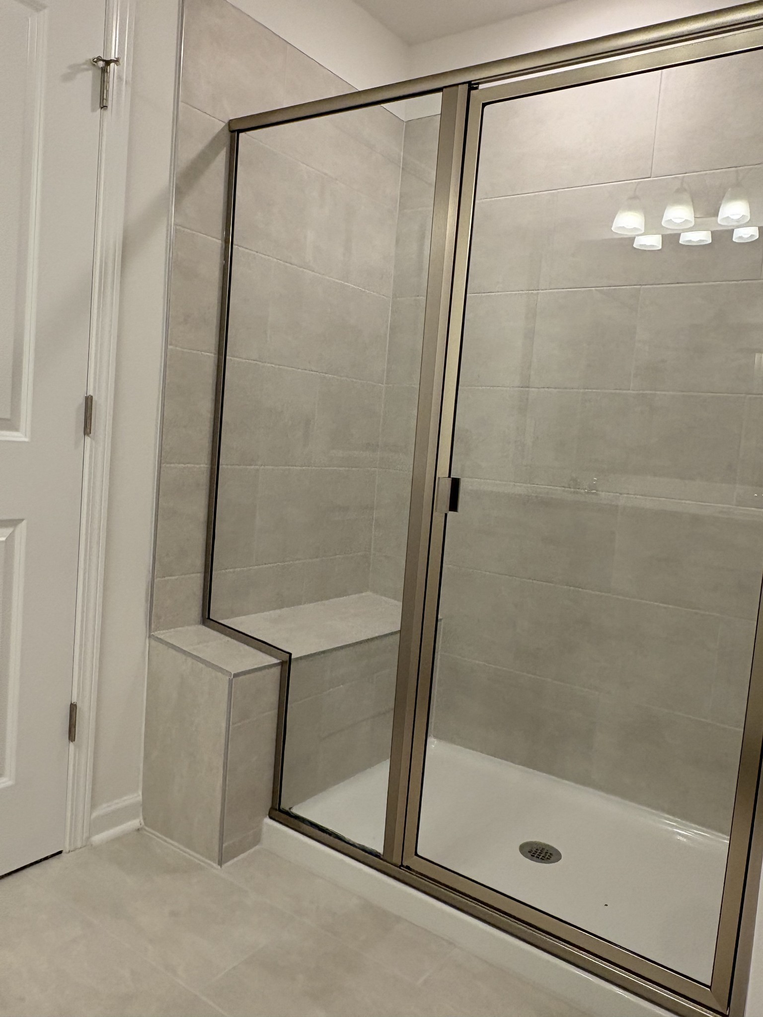 7144 Mapleside Lane, Unit 19 Fairview, TN 37062 - Photo 22 of 26 a bathroom with a glass shower door