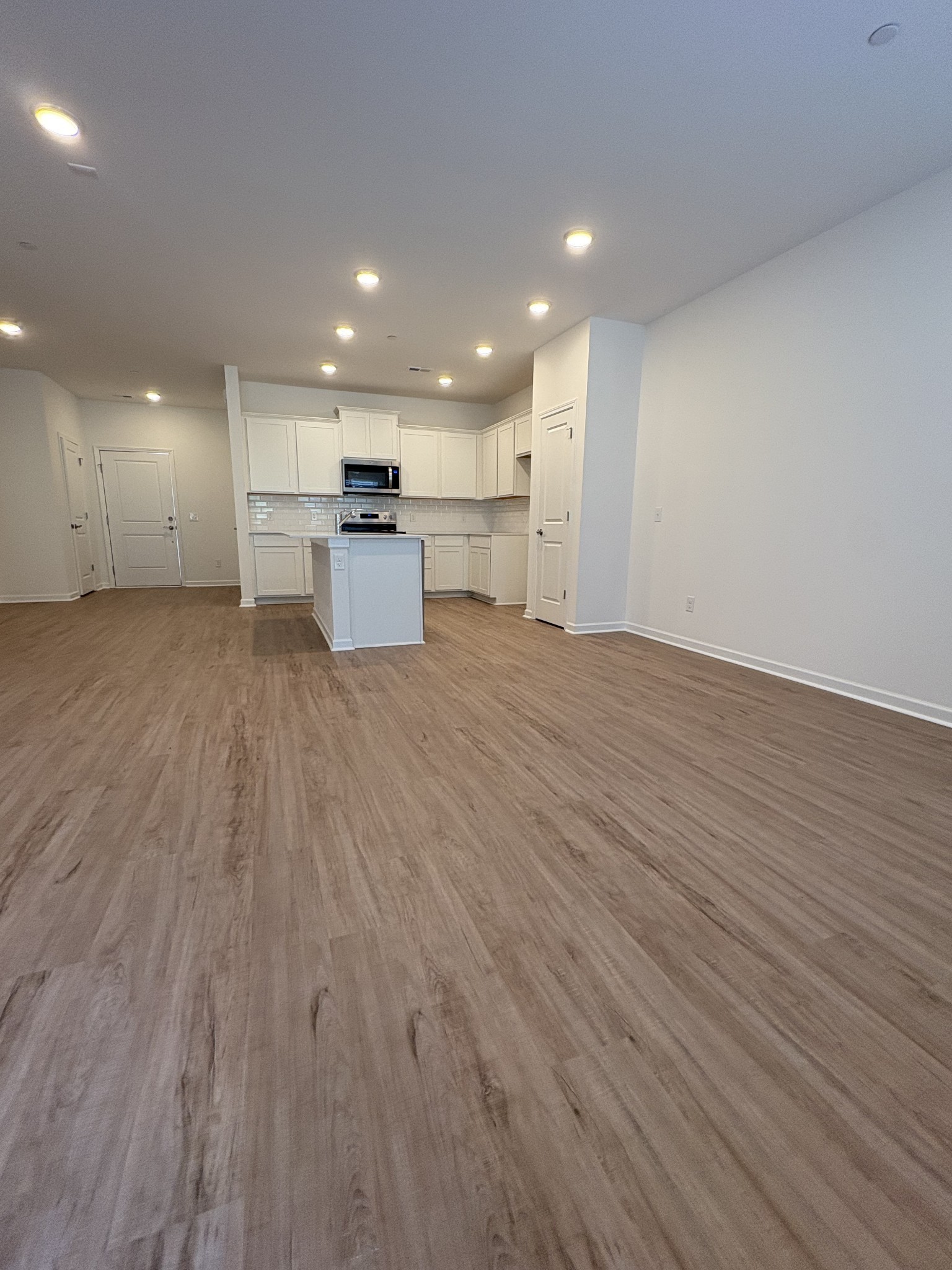 7144 Mapleside Lane, Unit 19 Fairview, TN 37062 - Photo 7 of 26 a view of kitchen with kitchen island wooden floor center island and stainless steel appliances