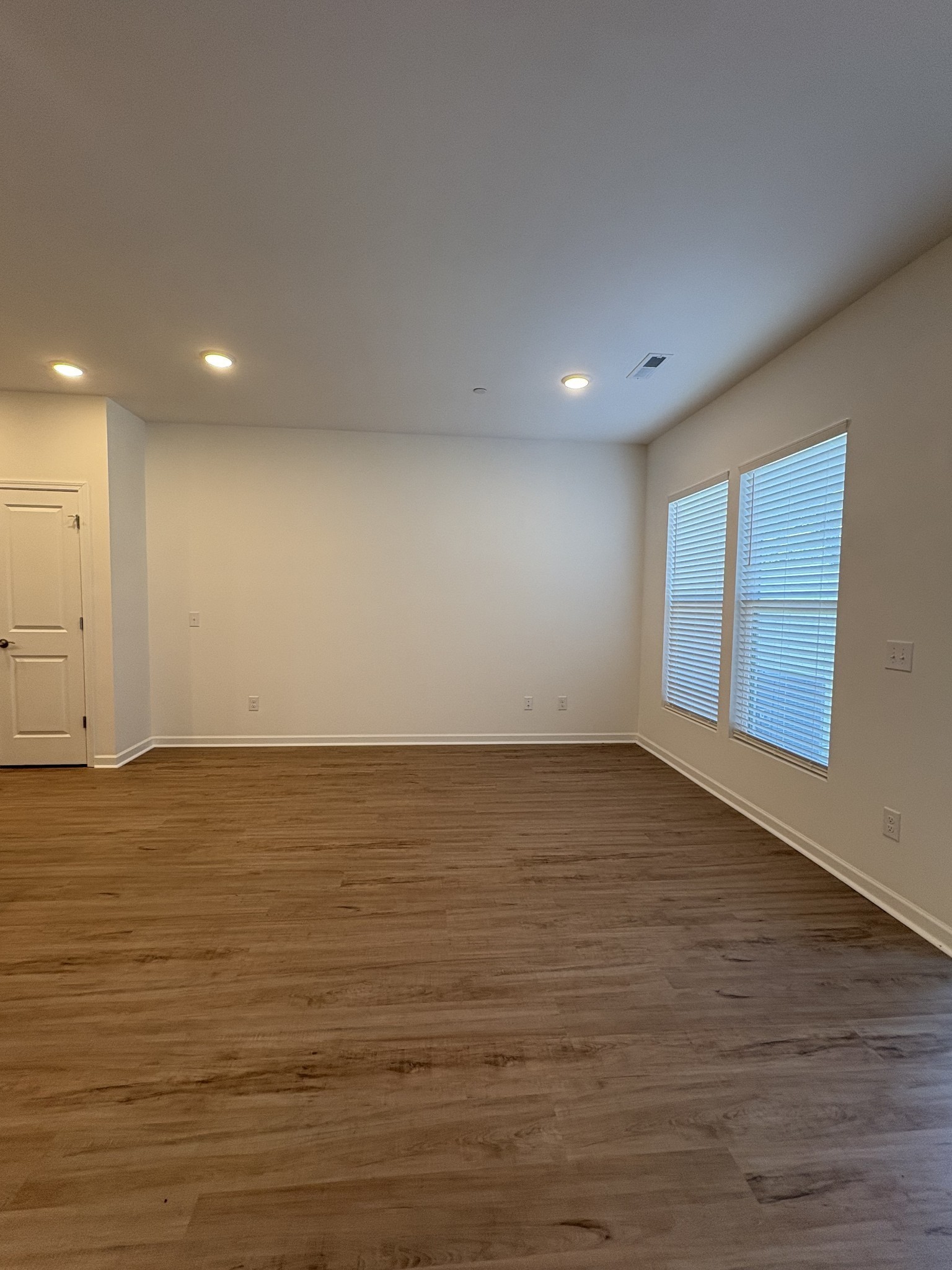 7144 Mapleside Lane, Unit 19 Fairview, TN 37062 - Photo 9 of 26 an empty room with wooden floor and windows