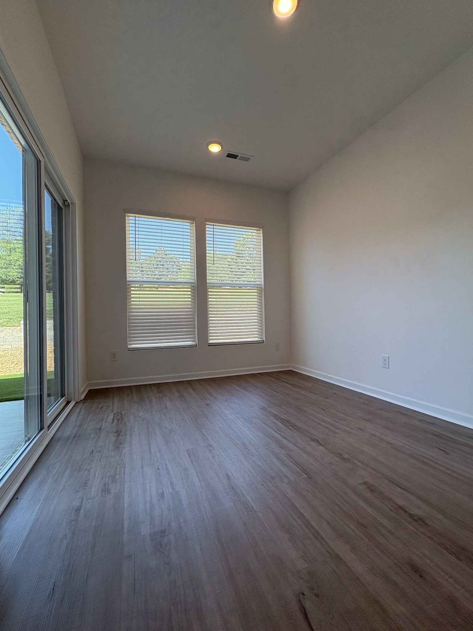 7144 Mapleside Lane, Unit 19 Fairview, TN 37062 - Photo 10 of 26 an empty room with wooden floor and windows