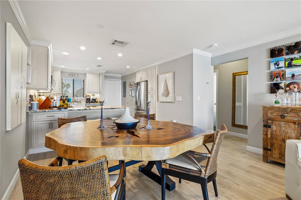 1602 Stickney Point Road, Unit 307 Sarasota, FL 34231 - Photo 12 of 56 a dining room with furniture and wooden floor