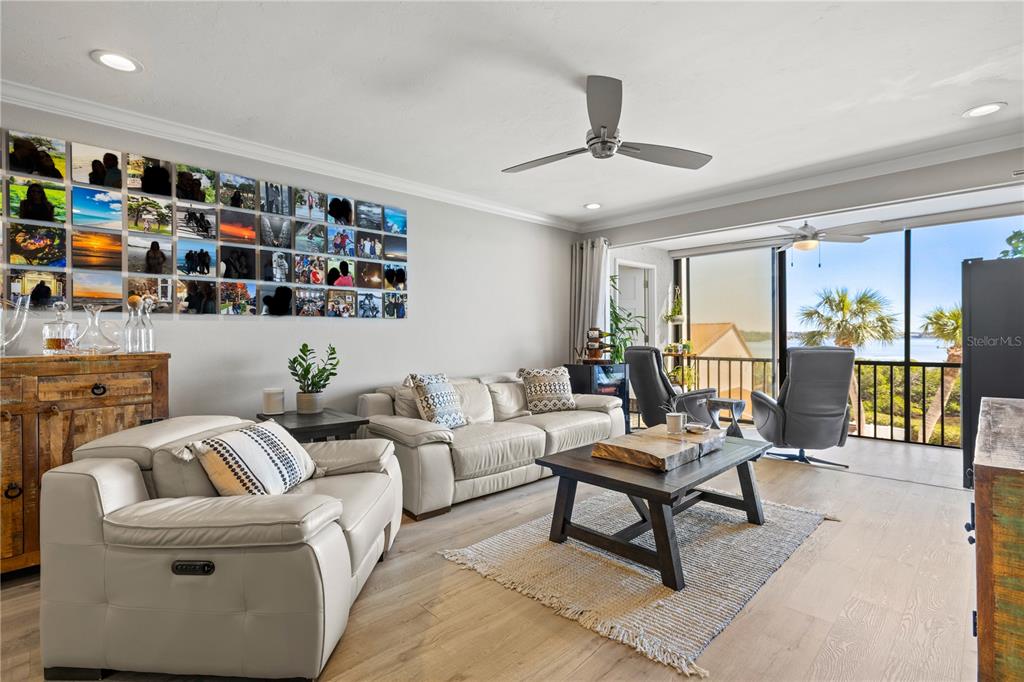 1602 Stickney Point Road, Unit 307 Sarasota, FL 34231 - Photo 14 of 56 a living room with furniture and a book shelf