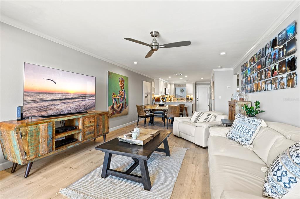1602 Stickney Point Road, Unit 307 Sarasota, FL 34231 - Photo 16 of 56 a living room with fireplace furniture and a flat screen tv