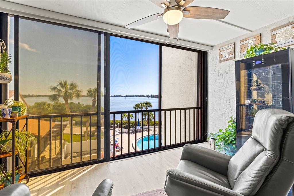 1602 Stickney Point Road, Unit 307 Sarasota, FL 34231 - Photo 18 of 56 a balcony with furniture and a chandelier