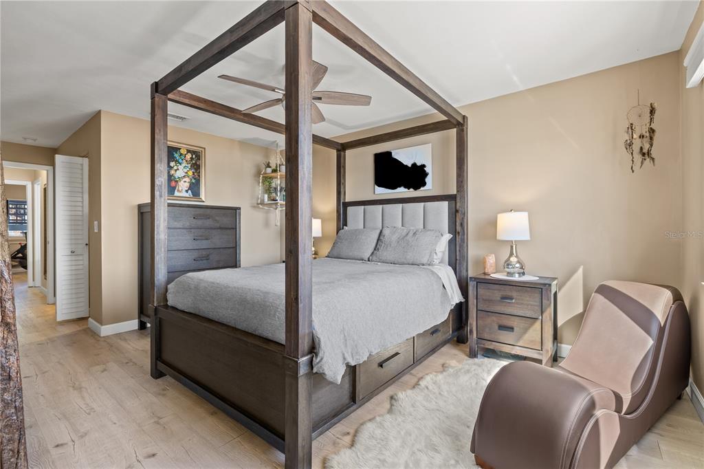 1602 Stickney Point Road, Unit 307 Sarasota, FL 34231 - Photo 21 of 56 a bedroom with a bed and wooden floor