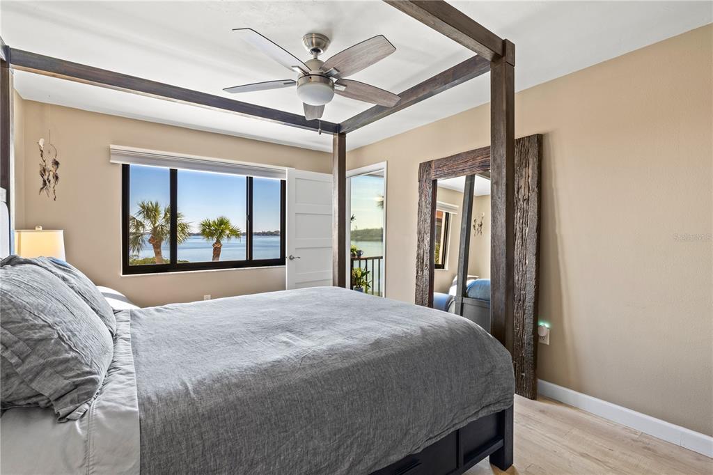 1602 Stickney Point Road, Unit 307 Sarasota, FL 34231 - Photo 24 of 56 a bedroom with a large bed and a large window