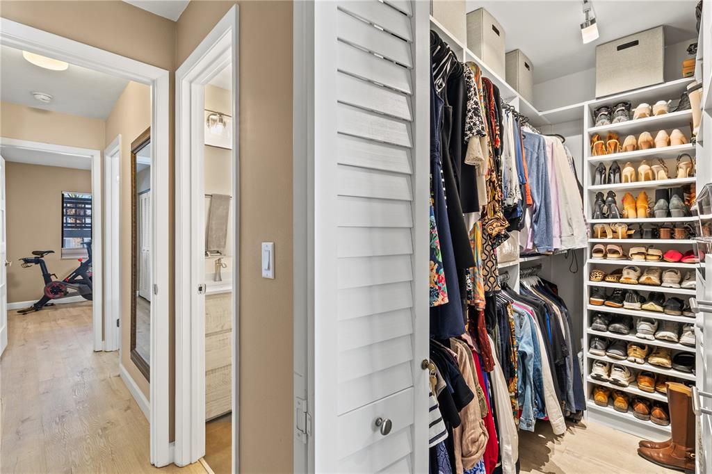1602 Stickney Point Road, Unit 307 Sarasota, FL 34231 - Photo 25 of 56 a view of walk in closet with clothes and shoes
