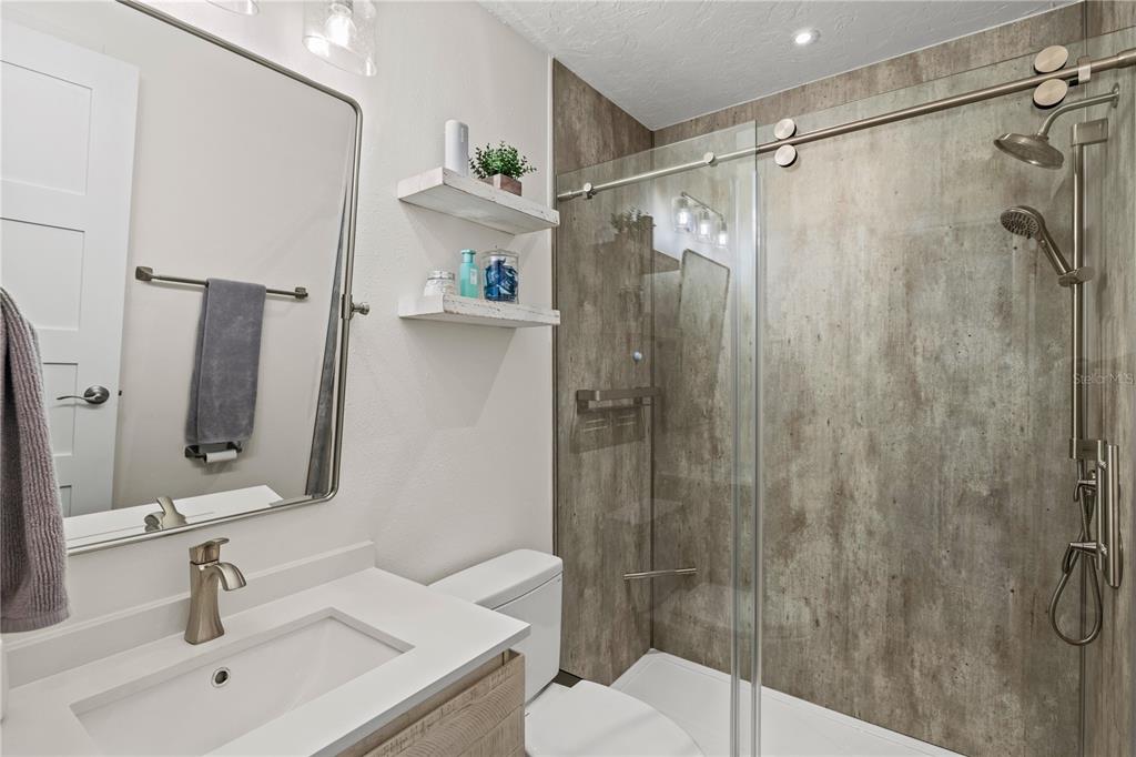 1602 Stickney Point Road, Unit 307 Sarasota, FL 34231 - Photo 26 of 56 a bathroom with a shower and a sink