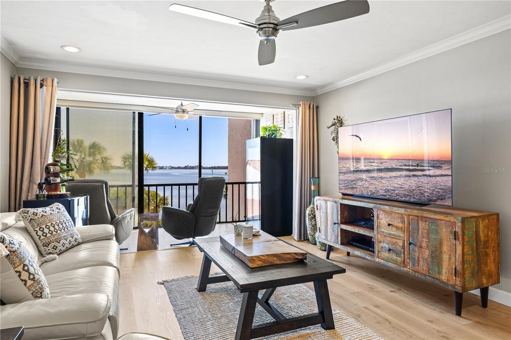 1602 Stickney Point Road, Unit 307 Sarasota, FL 34231 - Photo 3 of 56 a living room with furniture and a flat screen tv