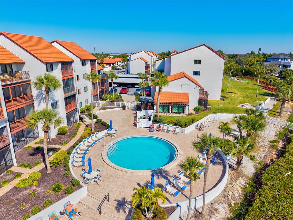 1602 Stickney Point Road, Unit 307 Sarasota, FL 34231 - Photo 52 of 56 an aerial view of a house with swimming pool and furniture