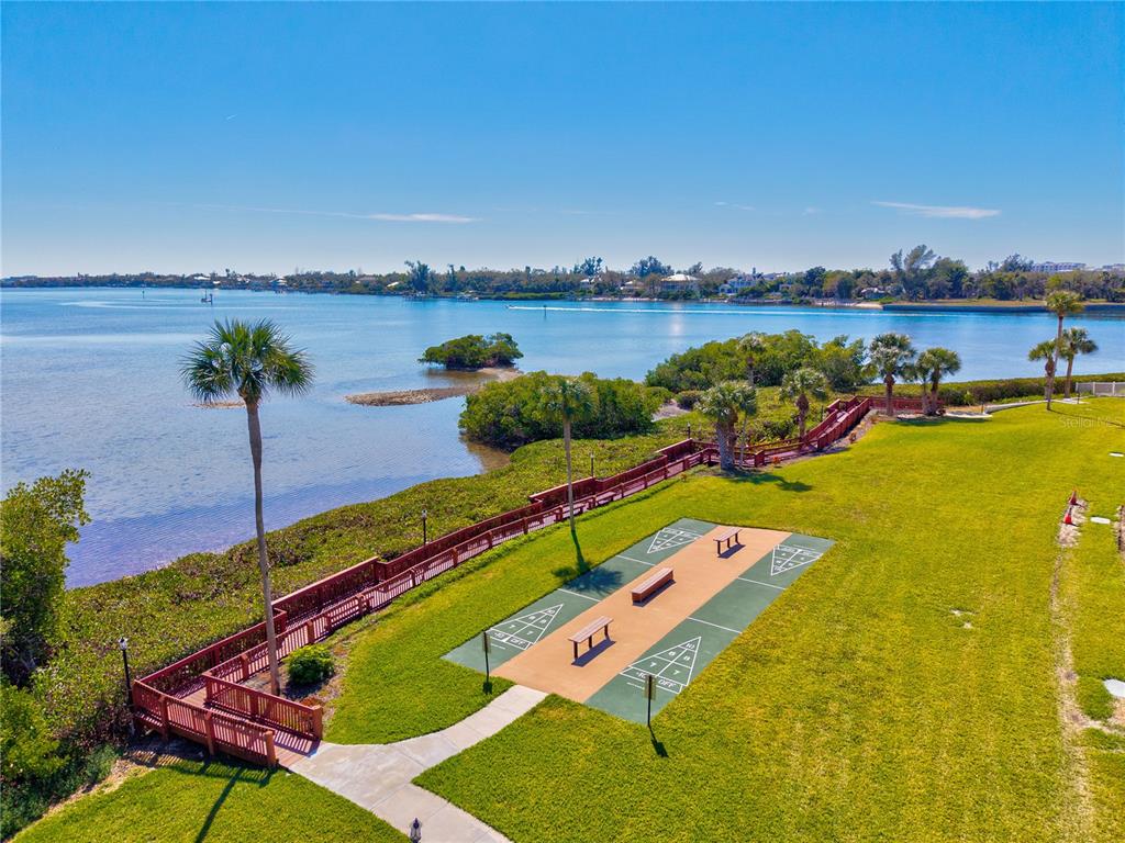 1602 Stickney Point Road, Unit 307 Sarasota, FL 34231 - Photo 56 of 56 a view of swimming pool with a table and chairs in patio