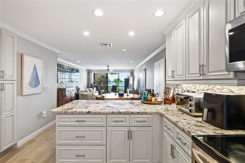 1602 Stickney Point Road, Unit 307 Sarasota, FL 34231 - Photo 8 of 56 a kitchen with sink stove and cabinets