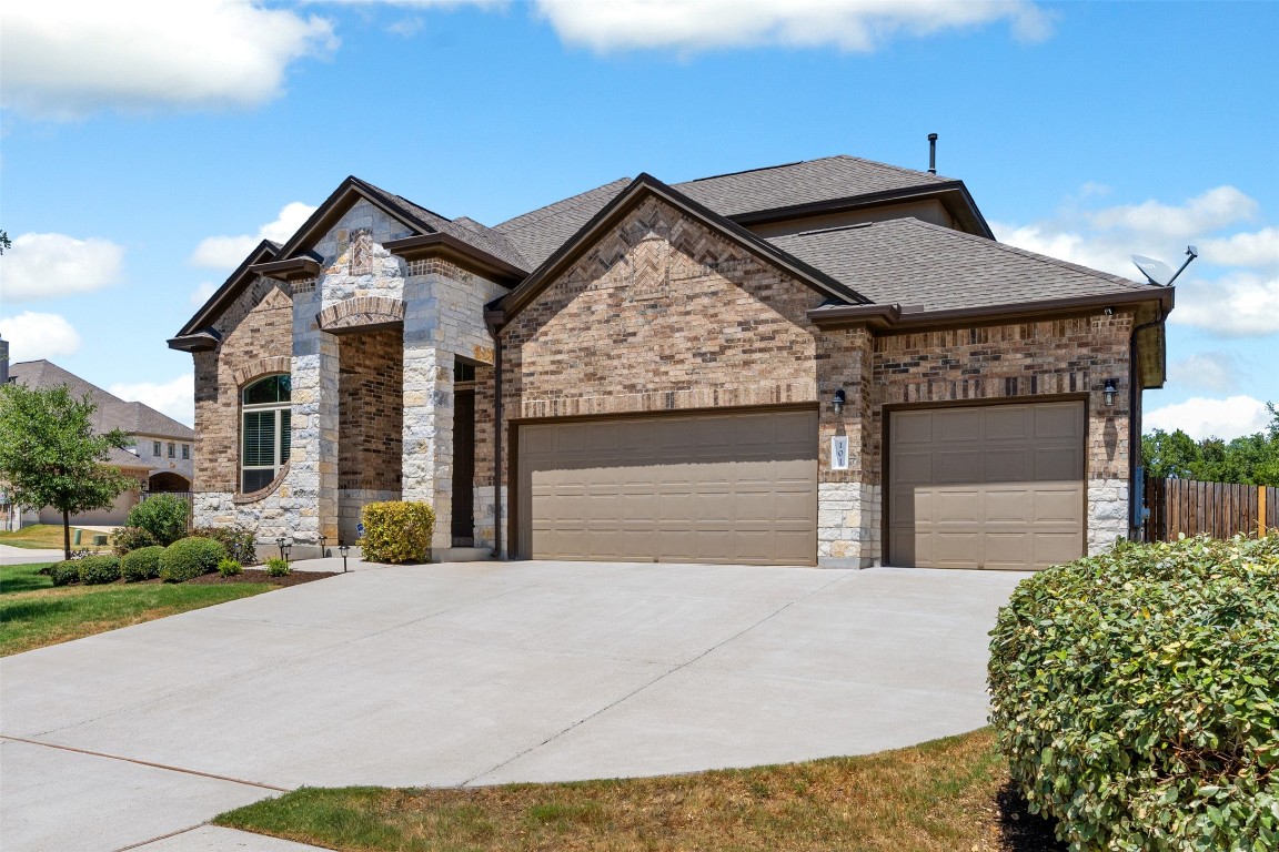a front view of a house with a garden and garage