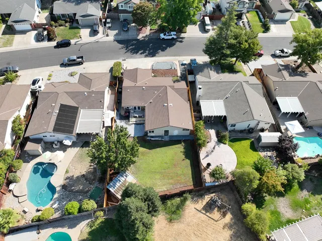 an aerial view of multiple houses with yard