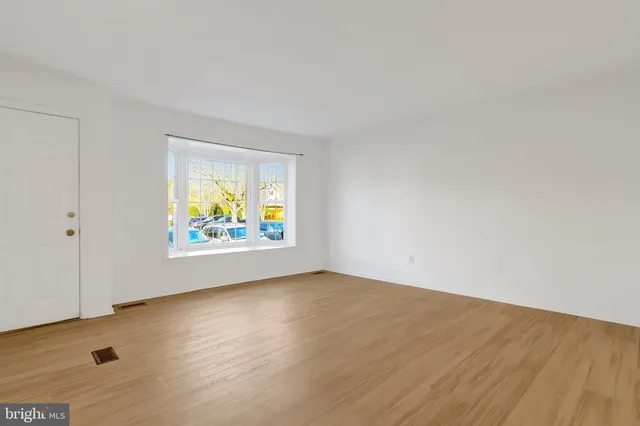 a view of a kitchen with wooden floor and a kitchen