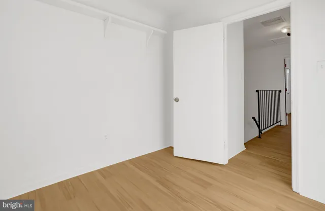 a view of a room with wooden floor and white walls