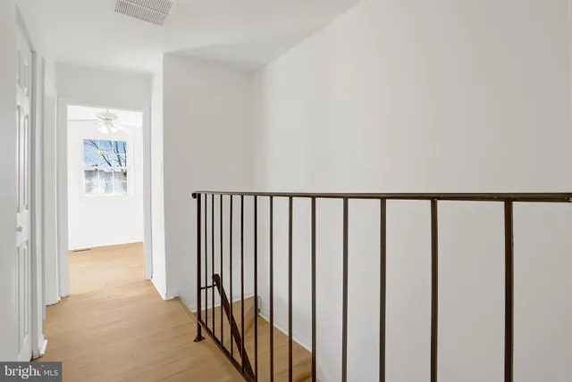 a view of an empty room with cabinet and a window