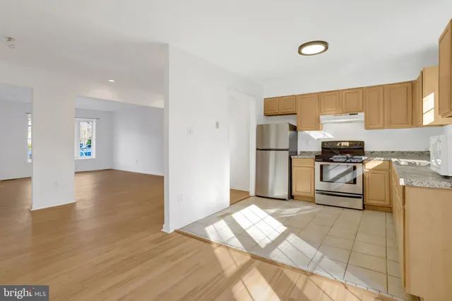 a kitchen with a sink cabinets and stainless steel appliances