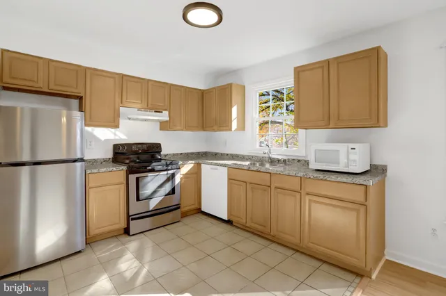 a kitchen with a refrigerator sink and stove