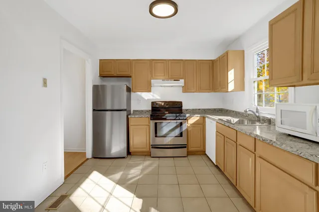 a bathroom with a granite countertop sink mirror and a
