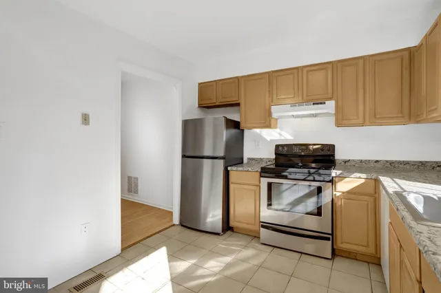 a view of a room with wooden floor and window