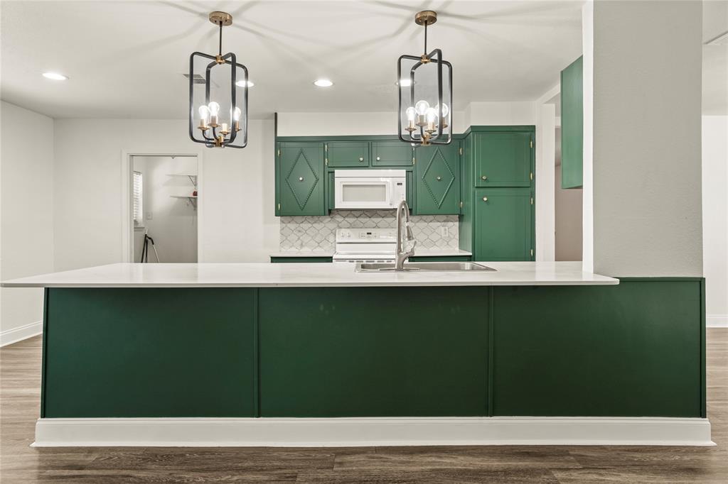 104 East Santa Anna Street Robinson, TX 76706 - Photo 19 of 36 a kitchen with a sink a refrigerator and chairs