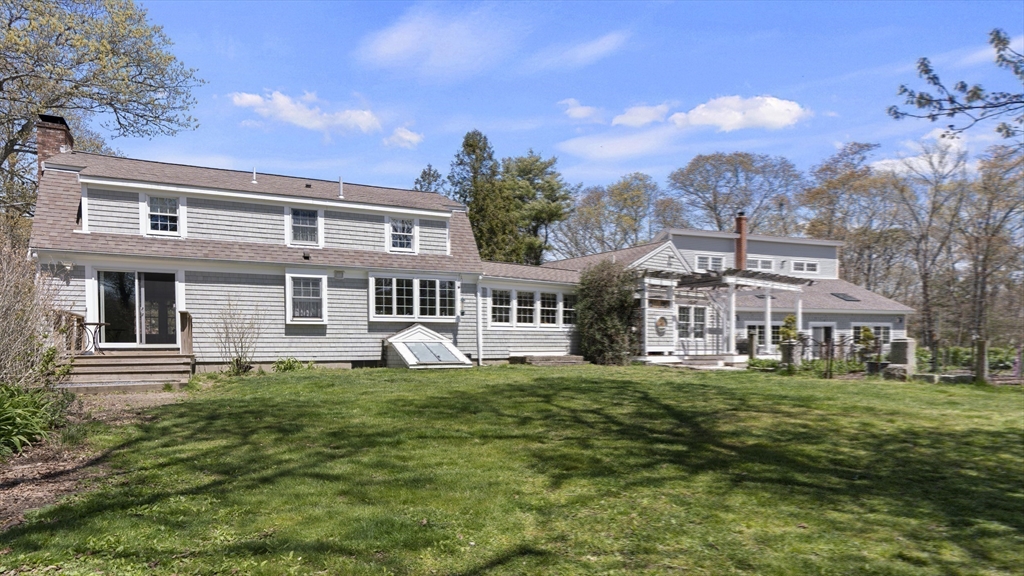 29 Back River Road Bourne, MA 02532 - Photo 31 of 37 a front view of a building with a garden
