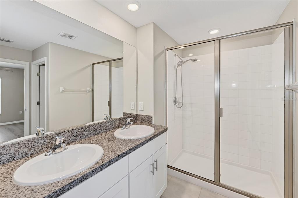 16751 Delia Street Wimauma, FL 33598 - Photo 12 of 36 a bathroom with a granite countertop sink mirror and double