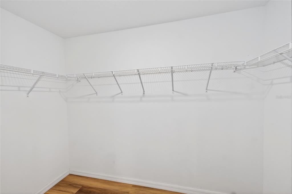 16751 Delia Street Wimauma, FL 33598 - Photo 13 of 36 a view of a room with racks on the wall