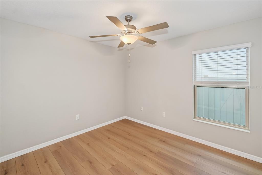16751 Delia Street Wimauma, FL 33598 - Photo 14 of 36 an empty room with a window and ceiling fan