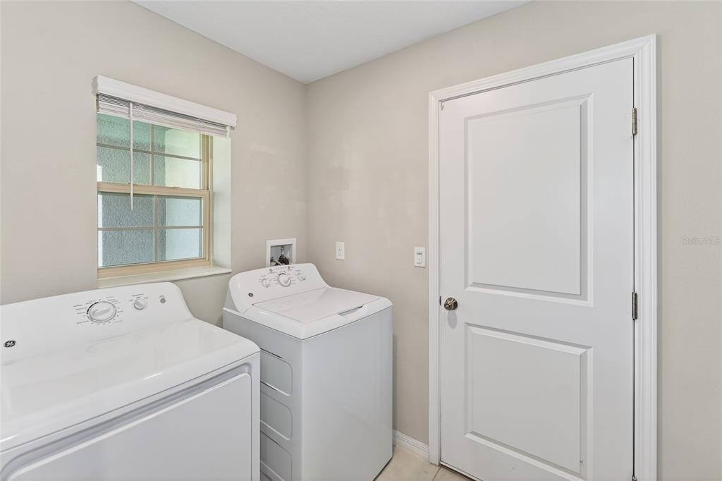 16751 Delia Street Wimauma, FL 33598 - Photo 19 of 36 a utility room with dryer and washer