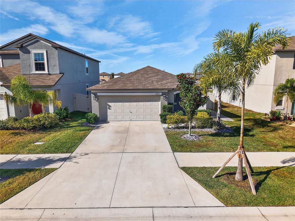 16751 Delia Street Wimauma, FL 33598 - Photo 29 of 36 a view of a house with a yard