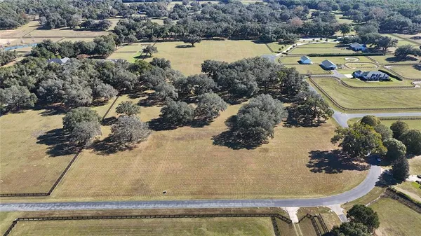 a view of swimming pool with a yard and lake view