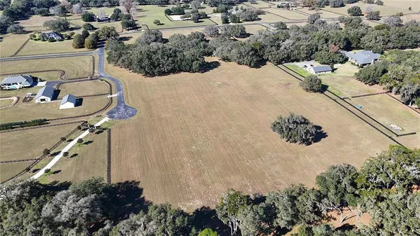 an aerial view of a house with a backyard